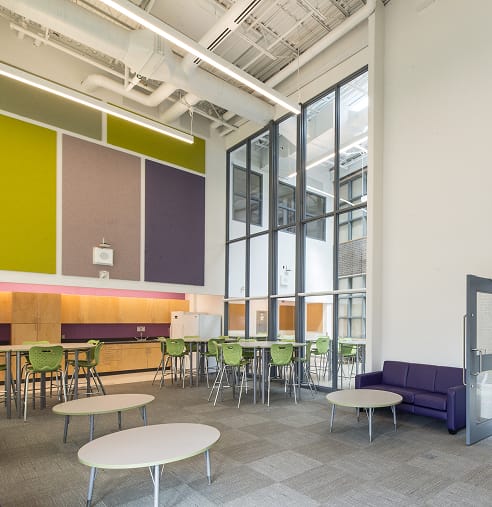 Large open area with tables and chairs, showcasing TOFCON's construction work for Agincourt Public School in Ottawa.