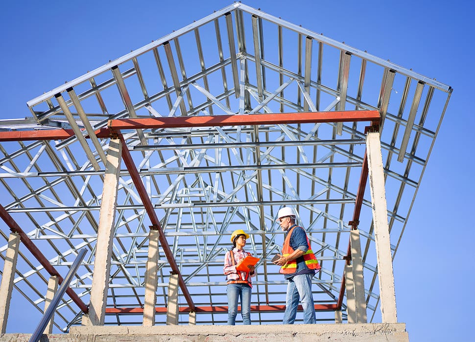 Two employees on a construction site with steel beams, representing TOFCON careers in commercial construction in Ottawa.