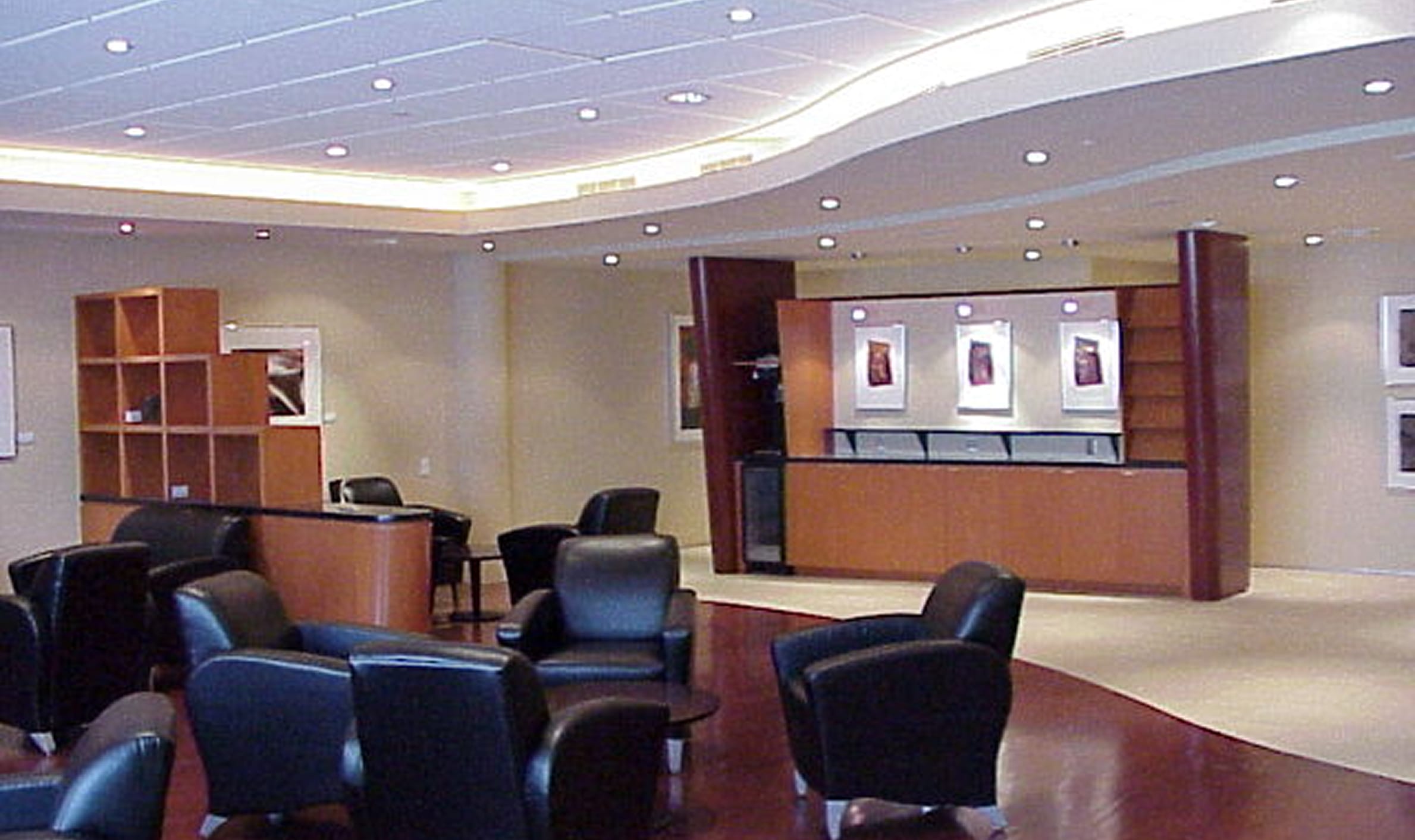 A spacious reception area featuring black leather chairs and a reception desk, designed for a Government of Canada centre.