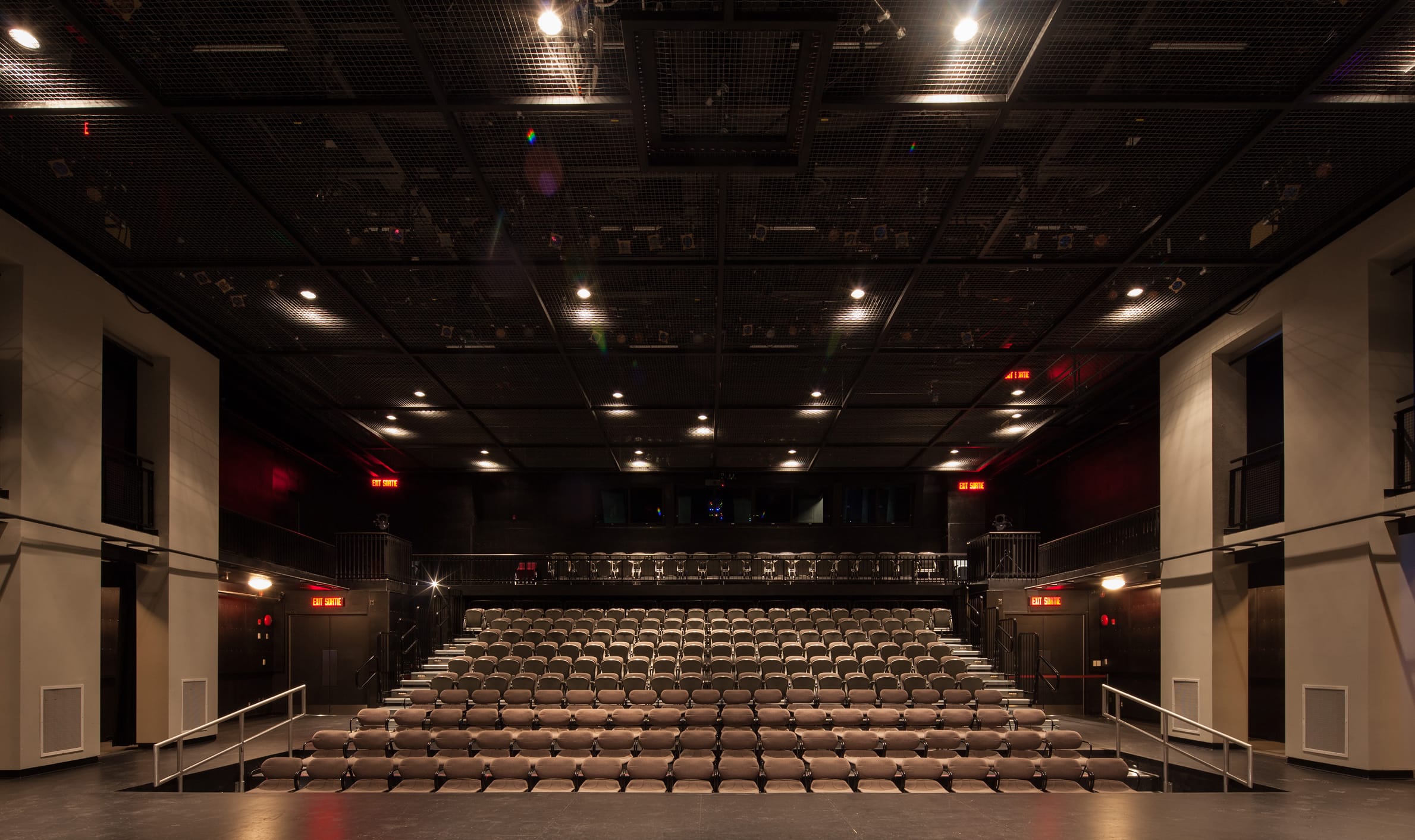 Interior view of a spacious auditorium with a stage and seating, highlighting TOFCON's construction project at Centrepoint Studio Theatre.