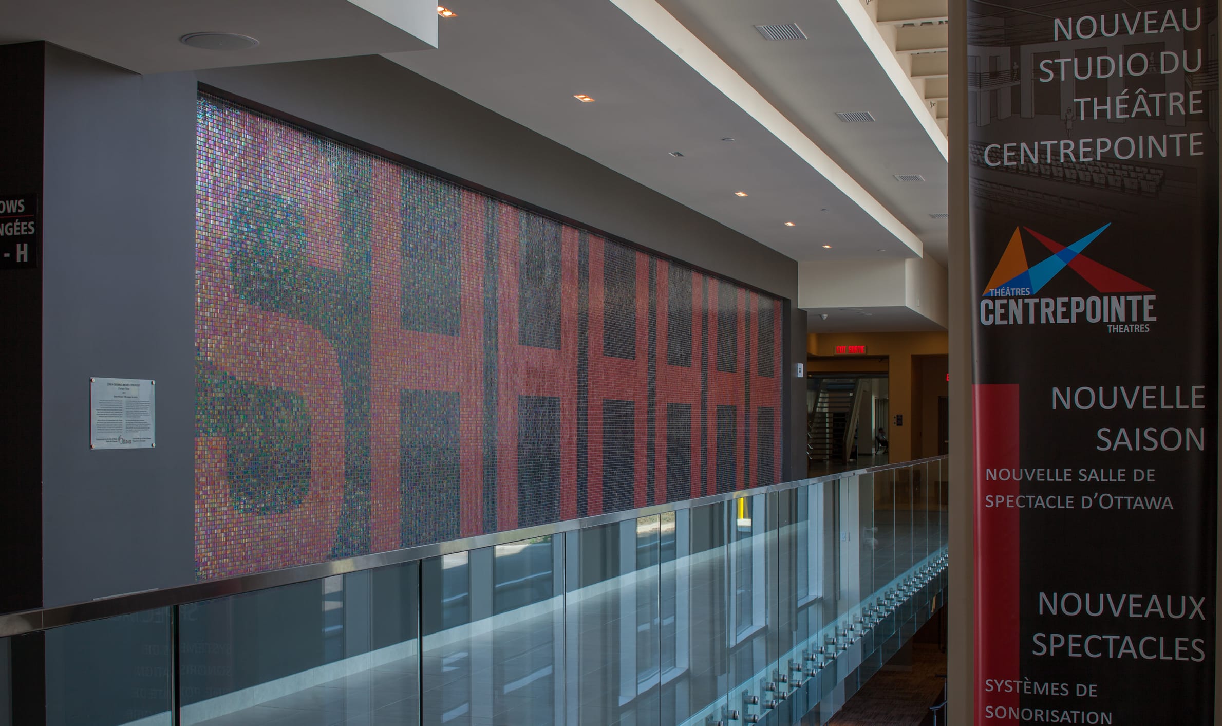 A large wall featuring a prominent painting, showcasing TOFCON's construction work at Centrepoint Studio Theatre in Ottawa.