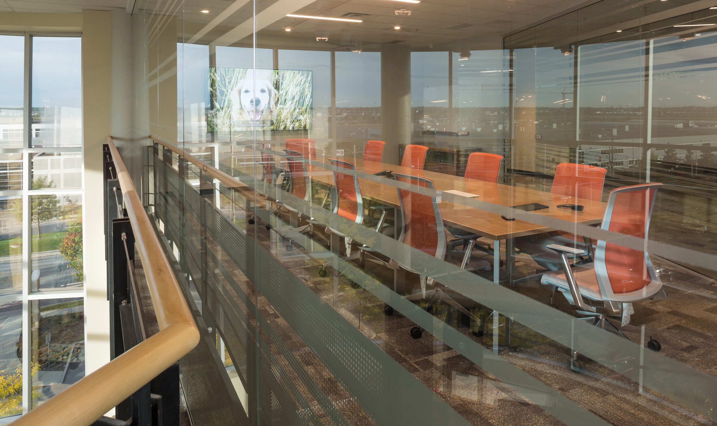Bright glass-walled room with a table and chairs, representing TOFCON's construction efforts for Kinaxis.