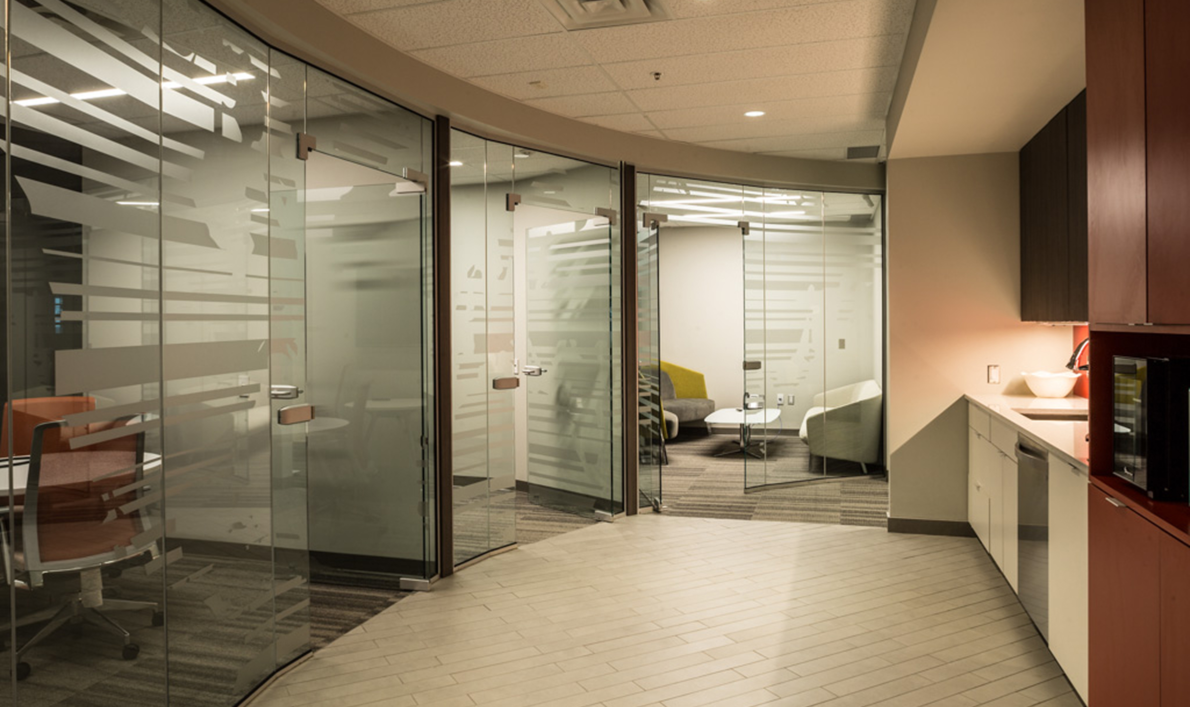 Glass-walled office featuring a curved wall, showcasing TOFCON's construction work for Kinaxis in Ottawa.