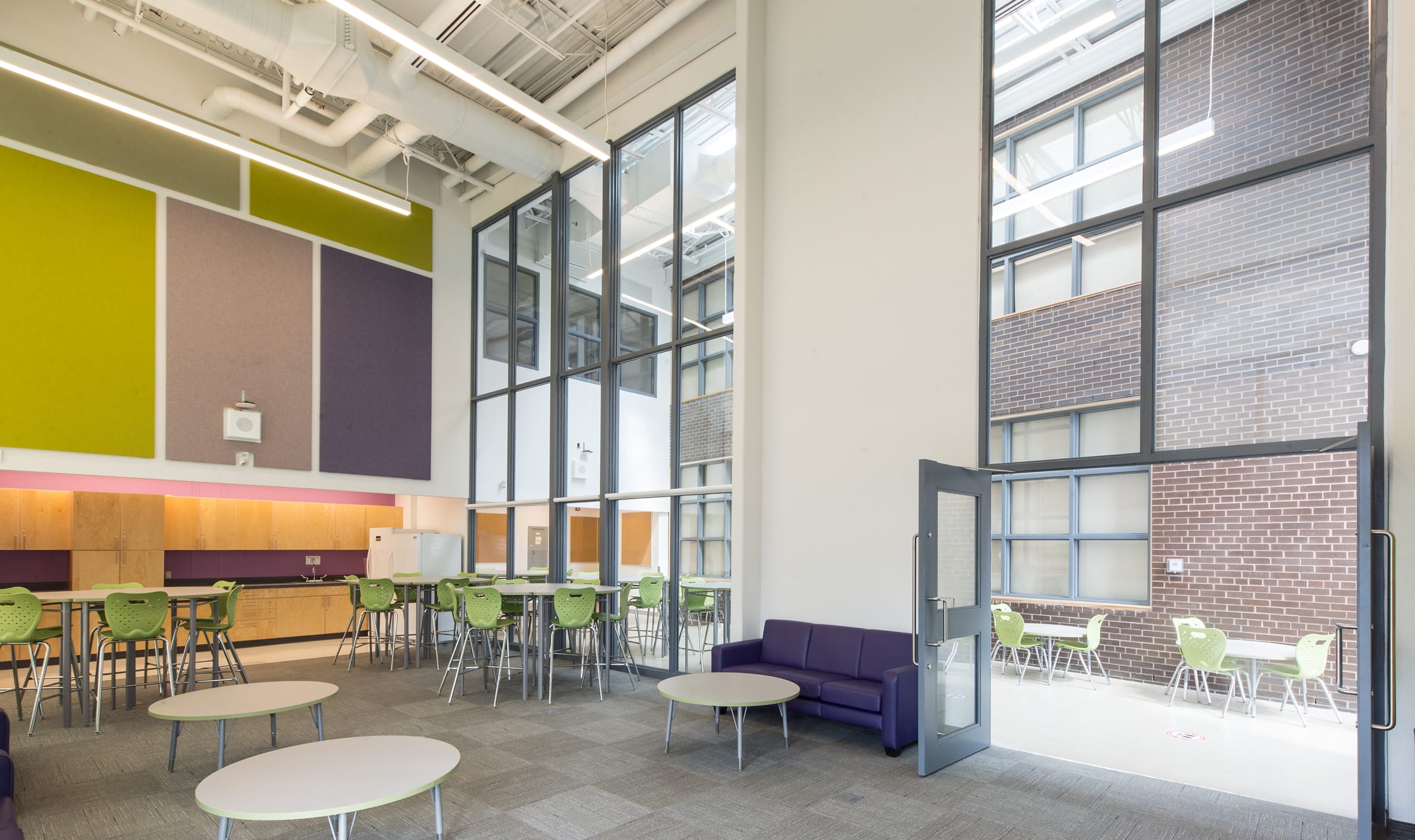 Spacious area featuring tables and chairs, highlighting TOFCON's commercial construction project at Agincourt Public School.