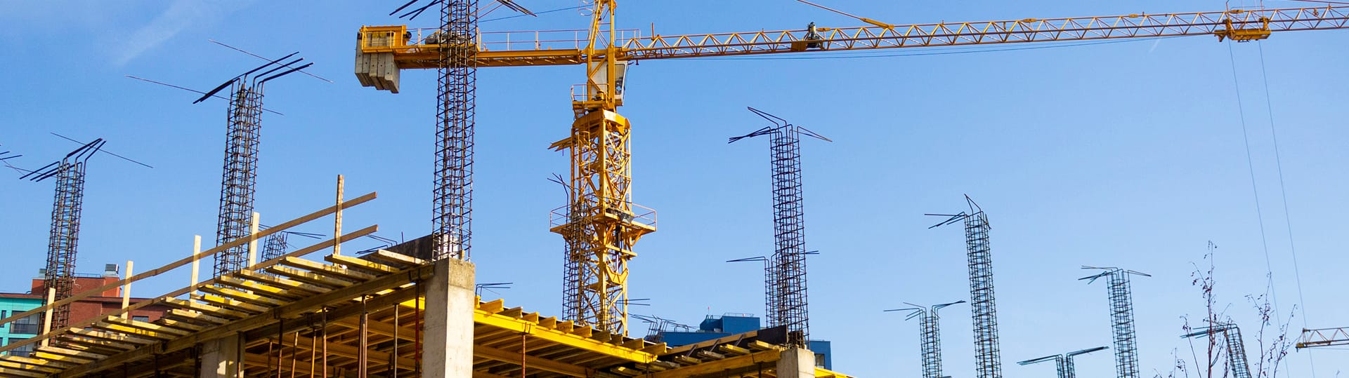 A crane is seen on a building under construction, representing TOFCON's commercial construction efforts in Ottawa.