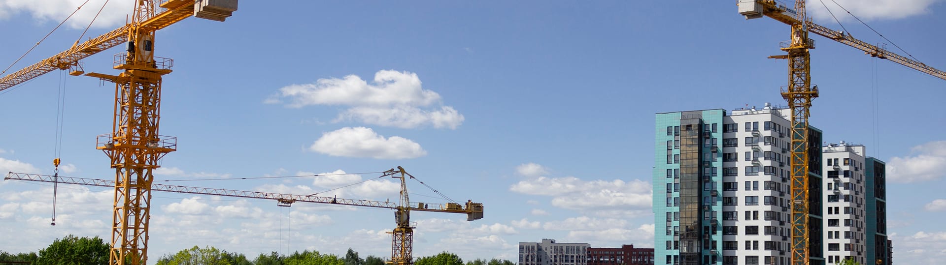 An active construction site in Ottawa with a crane and a developing commercial building, representing TOFCON's work.